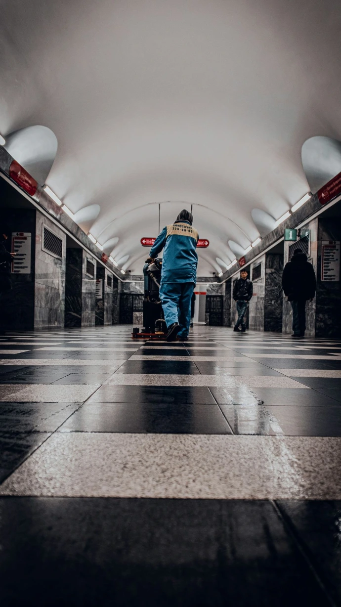 man in blue denim jeans walking on hallway